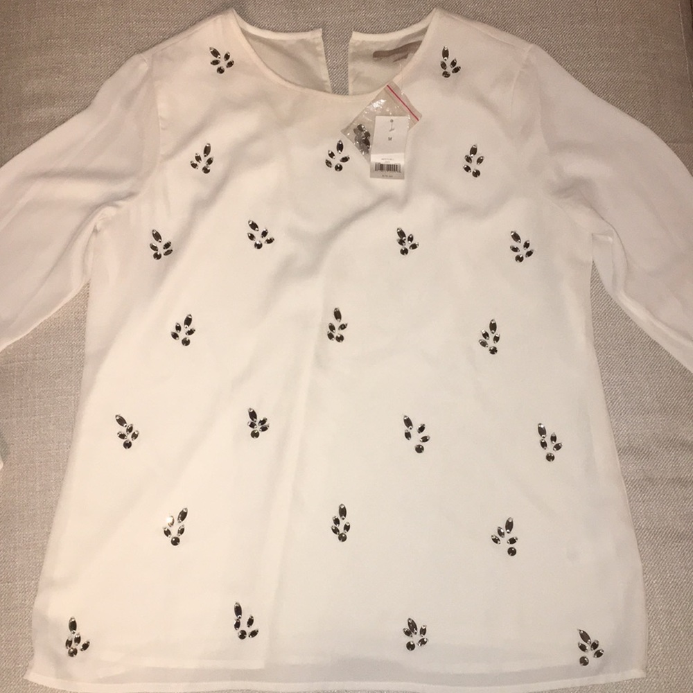 Long sleeve, cream blouse with gems.